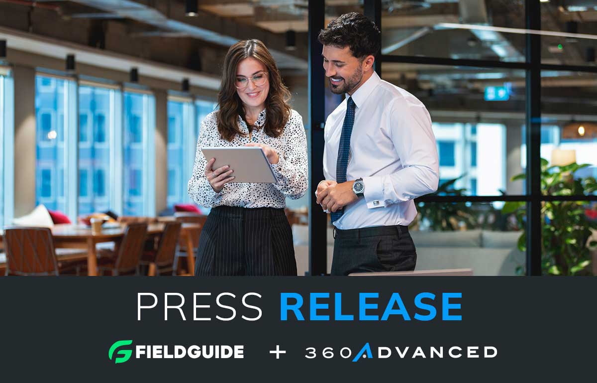 Graphic announcing a new press release. Image of a male and female coworker looking at a computer tablet in an office.