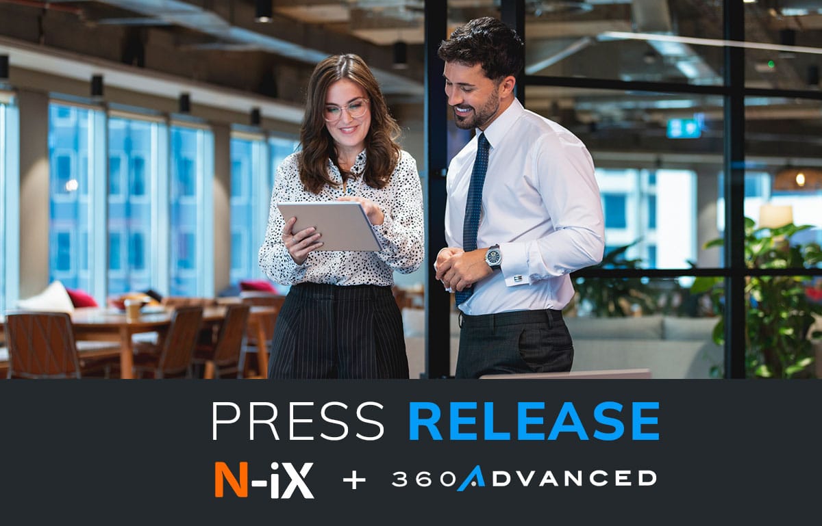 Graphic announcing a new press release. Image of a male and female coworker looking at a computer tablet in an office.
