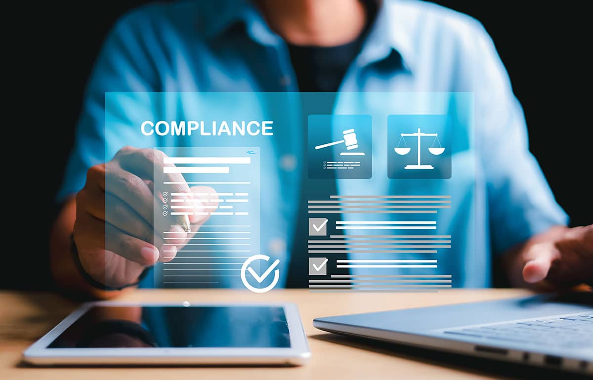 Image of man using computer and tablet with an audit diagram on virtual screen