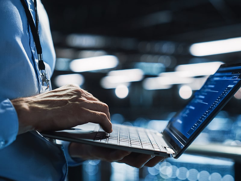 Data Center Programmer Using Digital Laptop Computer, Maintenance IT Specialist. Cloud Computing Server Farm System Administrator Working on Cyber Security for Iaas, saas, paas. Closeup Focus on Hands stock photo