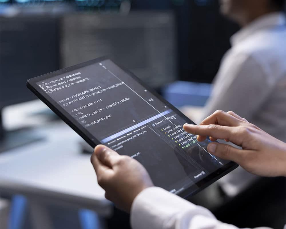 hands holding tablet with data folder organization on the screen