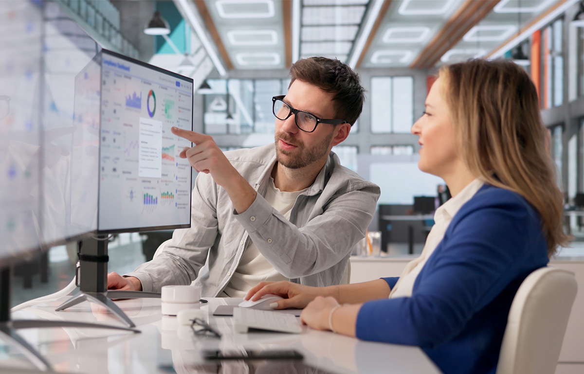 Compliance Specialist Analyzes Risk Analytics On Desktop For Regulatory Audit