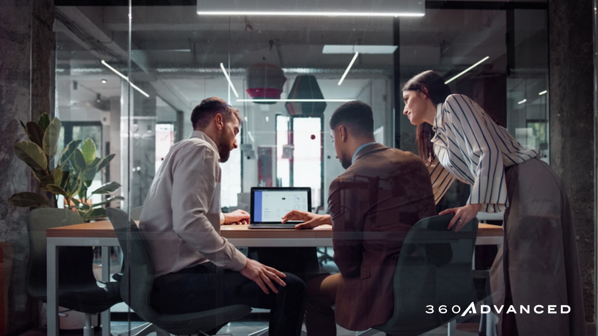 Business colleagues use AI software on laptop computer in business office setting